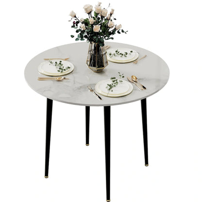 Table de salle à manger ronde avec plateau en marbre et pieds en métal, idéale pour la salle à manger ou la cuisine.