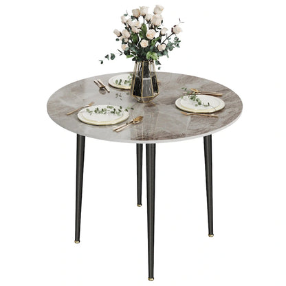 Table de salle à manger ronde avec plateau en marbre et pieds en métal, idéale pour la salle à manger ou la cuisine.